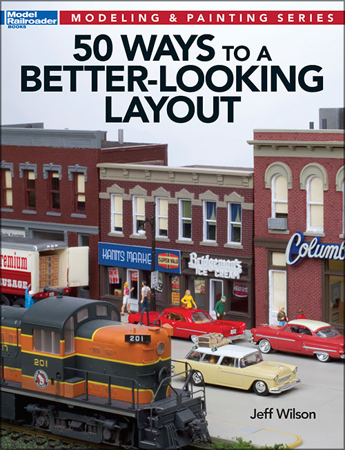 50 ways to a better looking layout cover shows a downtown scene and a diesel train model