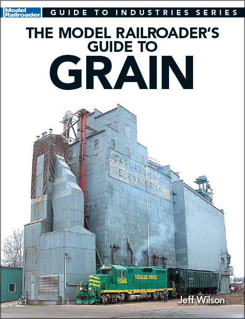 the model railroader's guide to grain cover shows a model of a large building next to a diesel locomotive