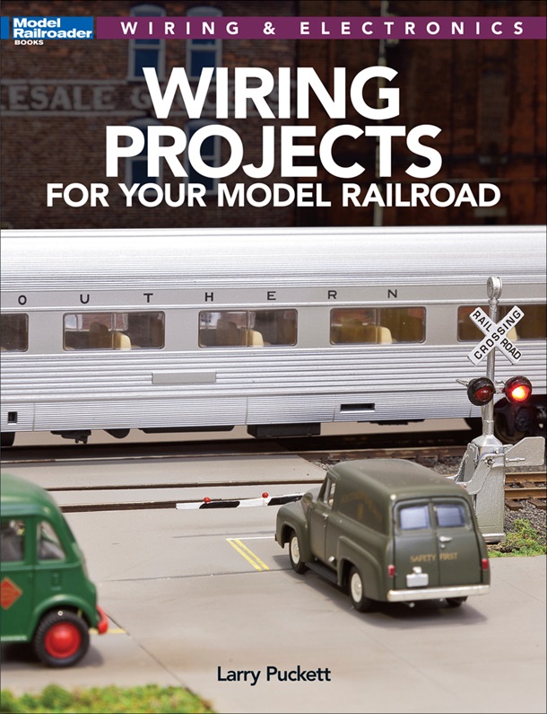wiring projects for you model railroad showig a passenger train in a train crossing on a layout