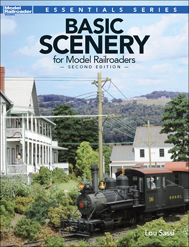 the cover showing a ho layout with a steam locomotive, houses, and nature