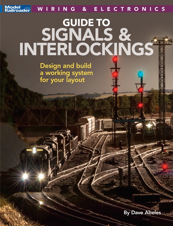 the cover shows a HO scale train yard with a diesel train by signal lights